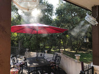 Outdoor patio with red umbrella, table, and chairs on a sunny day.