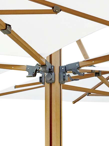 Close-up of a wooden patio umbrella with metal joints against a white background