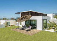 Modern house exterior with patio furniture and umbrella