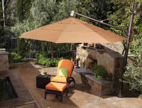 Patio with outdoor umbrella, chairs, and fireplace in a garden setting