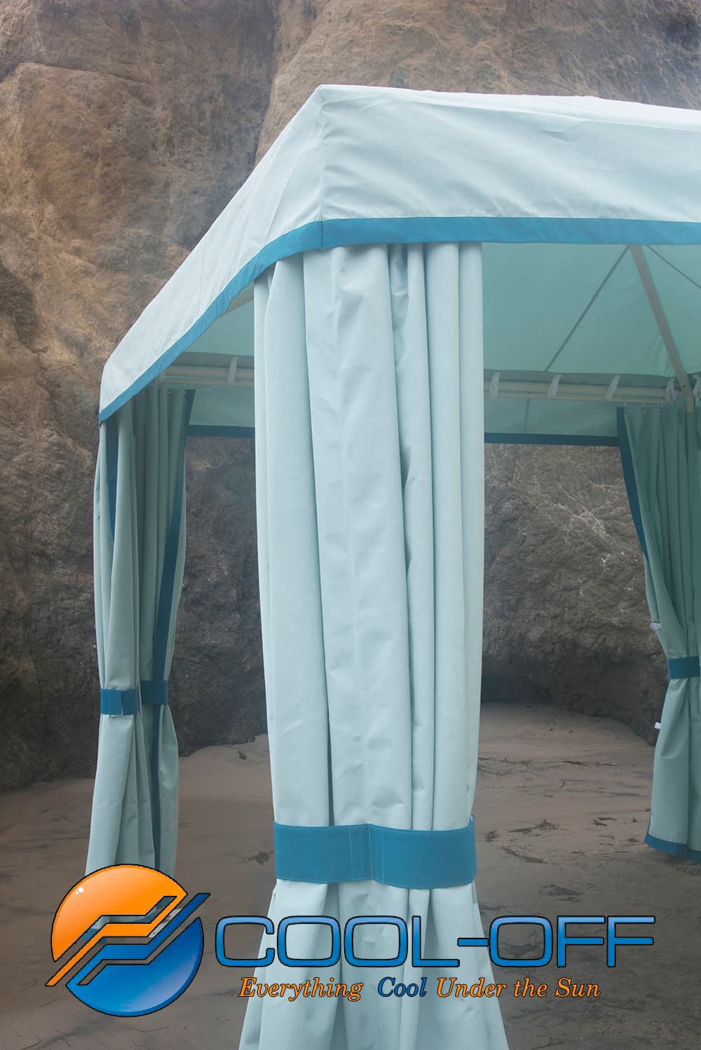 Outdoor canopy with curtains against a rocky background, featuring the 'Cool-Off' brand logo.