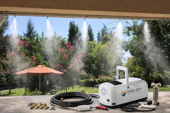 Misting system with a machine labeled 'Cool Off' in an outdoor setting with trees and flowers.