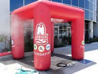 Red inflatable arch with Arby's Foundation logo in front of a building.