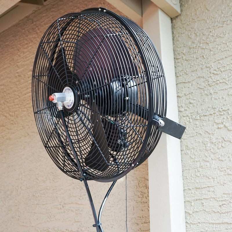 Wall-mounted fan attached to a building exterior