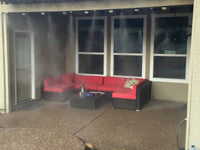 Red and black outdoor furniture set with misters on a patio