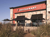 Restaurant exterior with a red facade and black awnings