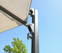 Beige outdoor umbrella with a metal stand against a clear blue sky