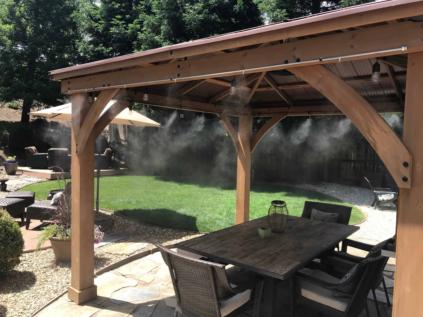 Outdoor patio with wooden pergola, table, and chairs on a misty day.