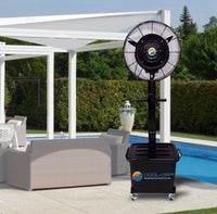 Outdoor standing fan on a patio with pool and chairs in the background