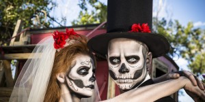 Characters: Skeleton bride wraps arms around groom. Spooky Halloween wedding.