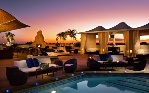 Outdoor pool lounge at sunset.